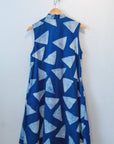 Display of blue sleeveless dress with white triangle print.