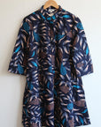 floral and leaf print navy dress on white background