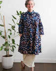 model wearing navy floral and leaf print dress