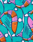 Close up display of teal dress with pink and orange shrimp print, fabric.