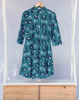 Display of dress with teal shaded loop print.