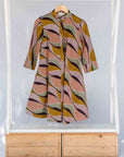 Display of neutral color geometric print dress.