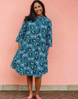 Model wearing dress with teal shaded loop print.