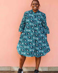 Model wearing dress with teal shaded loop print.