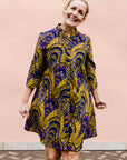 model wearing a gold and purple empire state building design dress