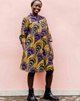 model wearing a gold and purple empire state building design dress