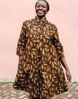 model wearing a brown, black and white seed design dress