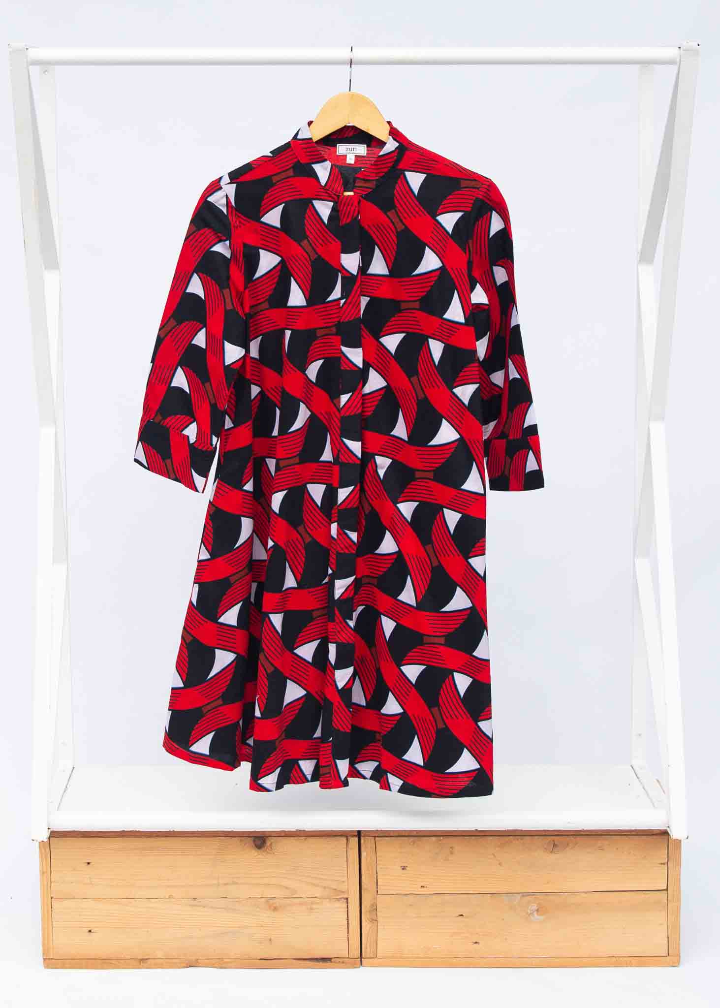 Display of red, black and white ribbon print dress.