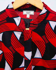 Display of red, black and white ribbon print dress.