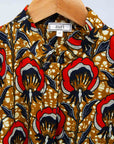 Display of mustard long sleeve blouse with red floral print.