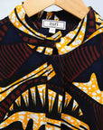 Display of long sleeve blouse with brown and yellow abstract print.
