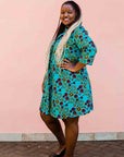 model wearing a green, red and yellow vegetable design dress