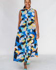 Model wearing blue dress with yellow, black, orange and white geometric print.