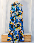 Display of blue dress with yellow, black, orange and white geometric print.