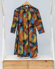 Display of black dress with rainbow brushstroke print.