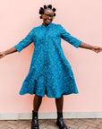 Model wearing blue squiggle print dress.