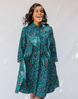 model wearing teal printed dress