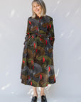 model wearing abstract geometric midi-length belted dress
