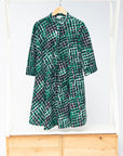 Display of black, green and white geometric print dress