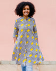 Model wearing black and white striped dress with yellow block print.