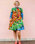 model wearing a rainbow swirl design dress