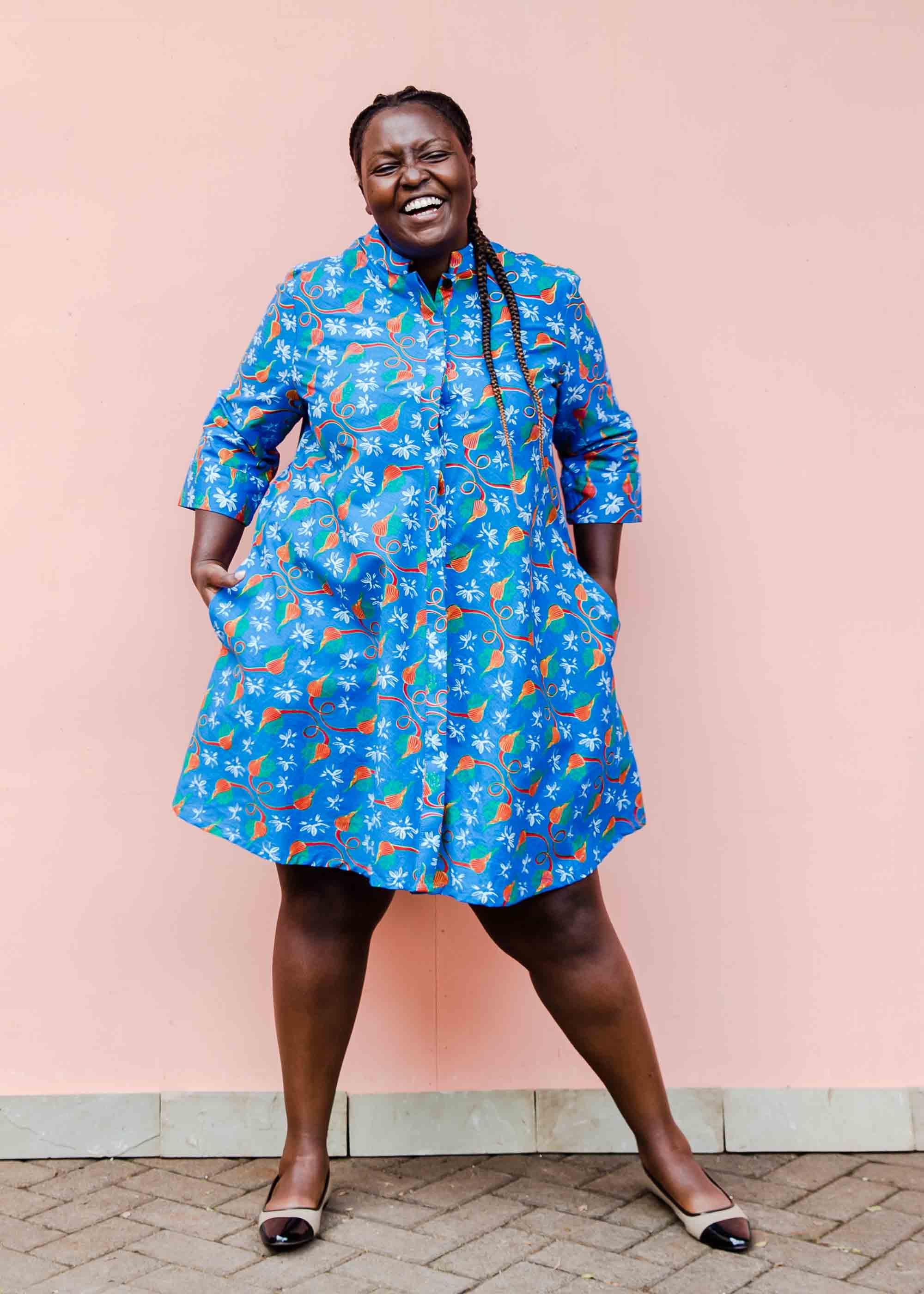 model wearing a blue, red and white flower pod design shirt dress