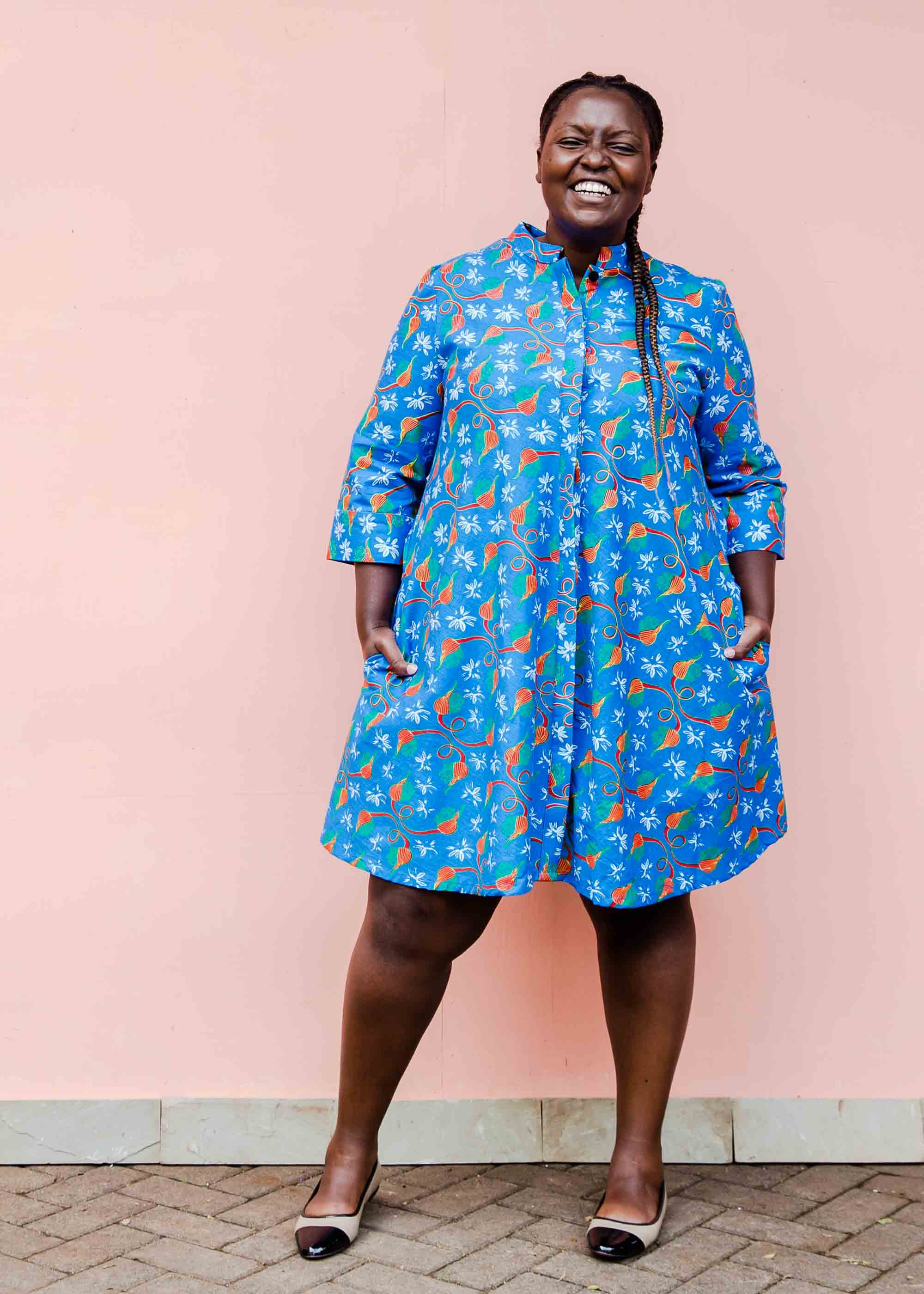 model wearing a blue, red and white flower pod design shirt dress