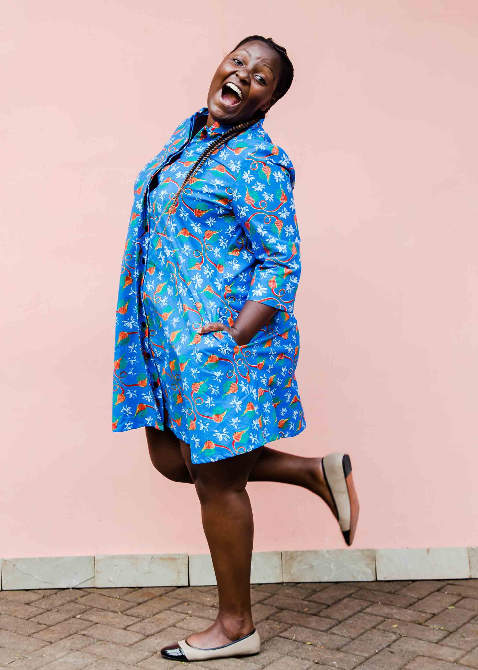 model wearing a blue, red and white flower pod design shirt dress