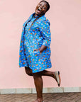 model wearing a blue, red and white flower pod design shirt dress