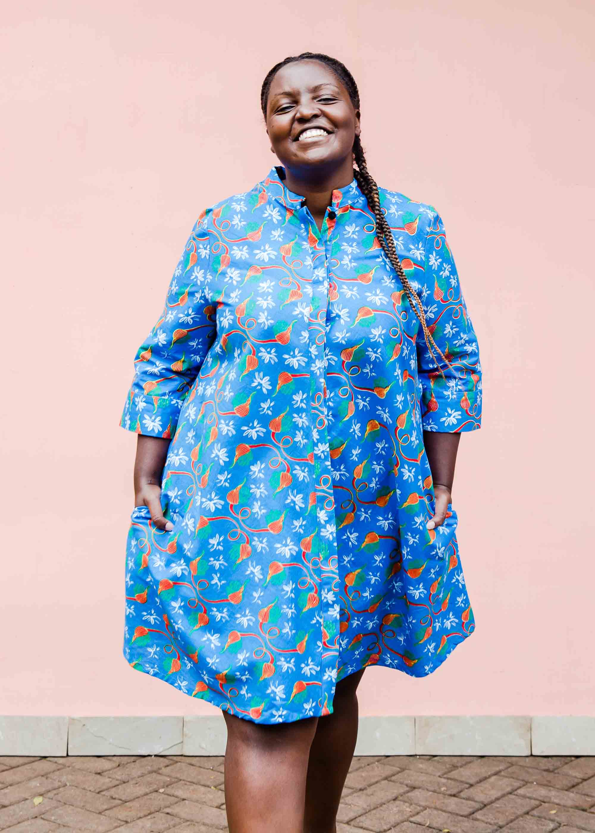 model wearing a blue, red and white flower pod design shirt dress