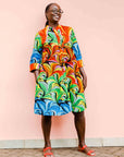 model wearing a rainbow swirl design dress
