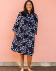 Model wearing navy dress with white floral print.