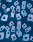 Close up display of blue, white domino print shirt, fabric.