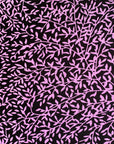 Close up display of black and purple floral print sleeveless shirt, fabric.