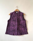 Display of black and purple floral print sleeveless shirt.