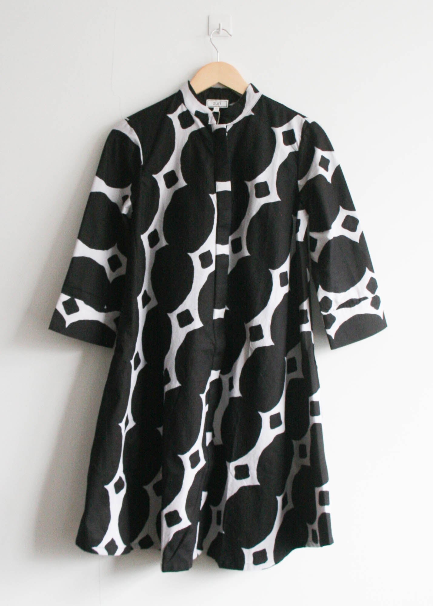 Display of black and white geometric print dress.