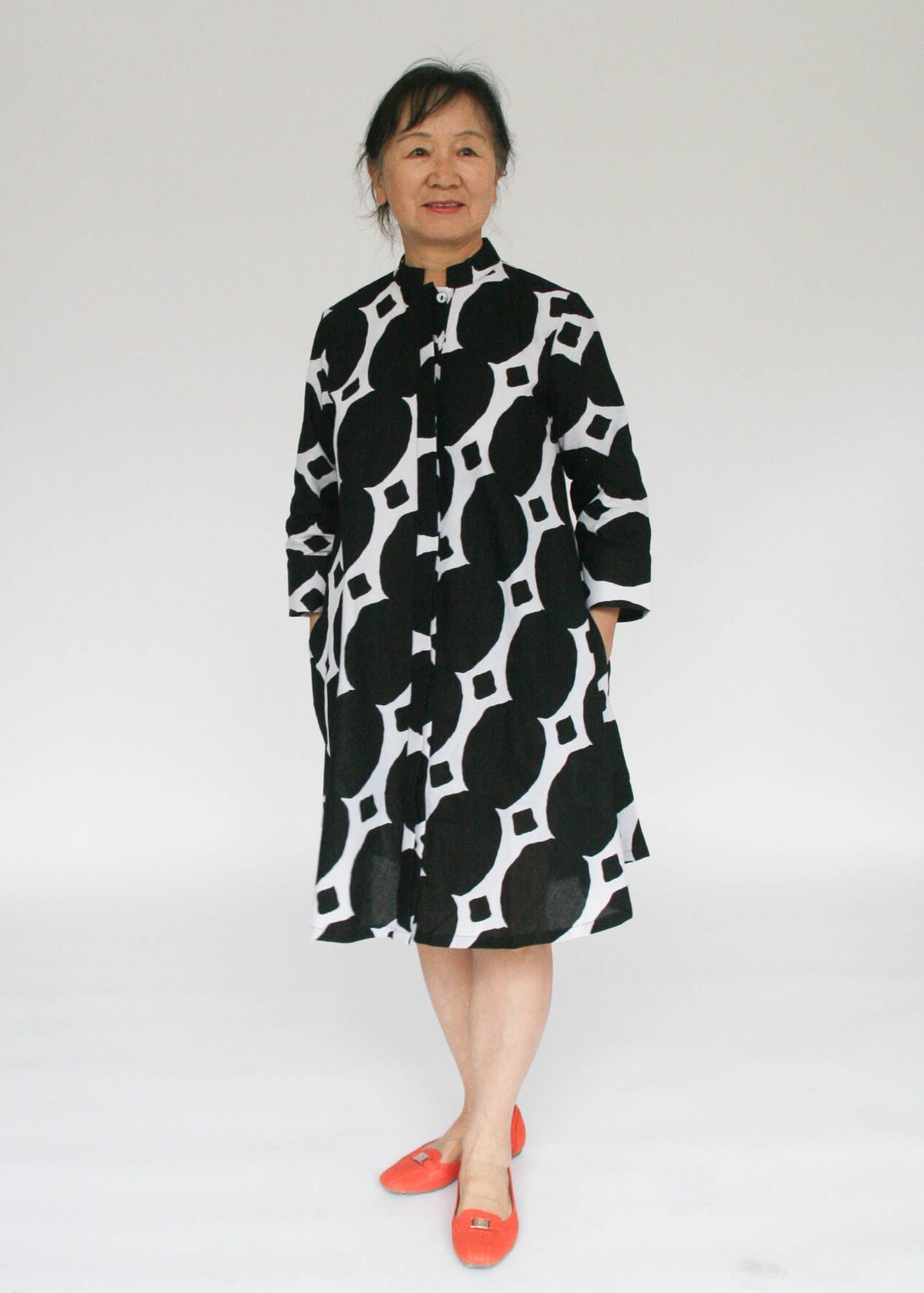 Model wearing black and white geometric print dress.