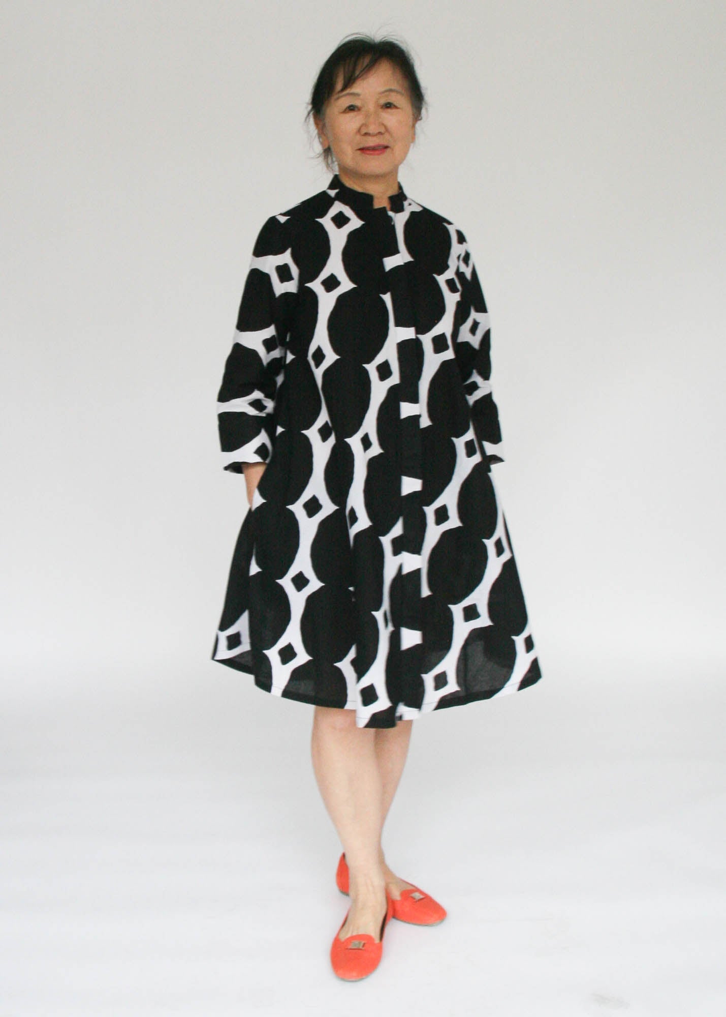 Model wearing black and white geometric print dress.