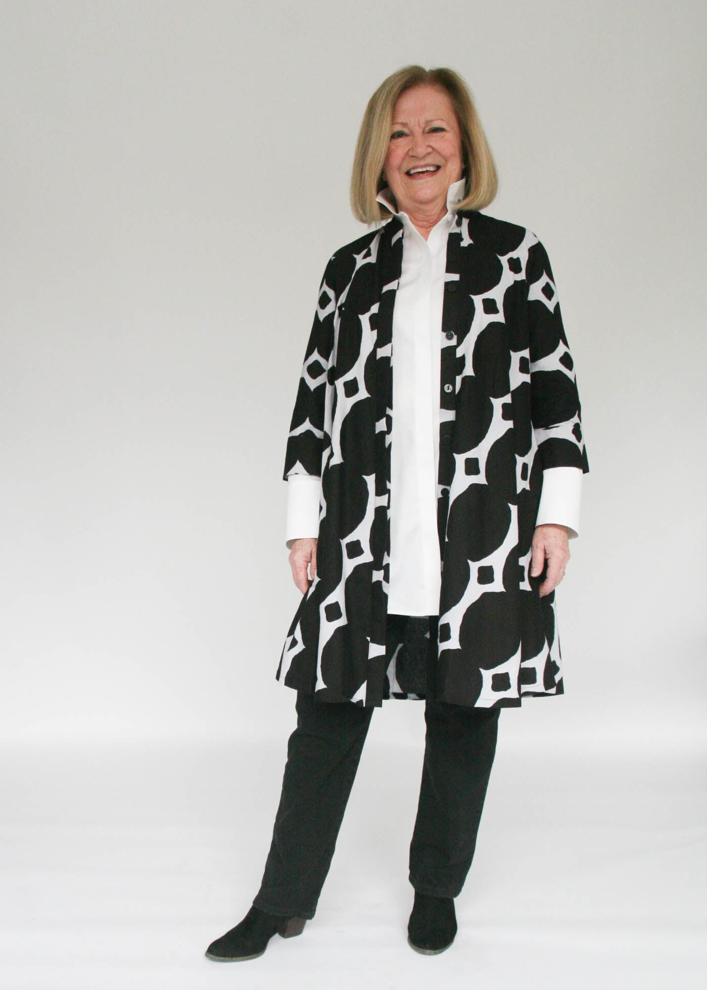 Model wearing black and white geometric print dress.