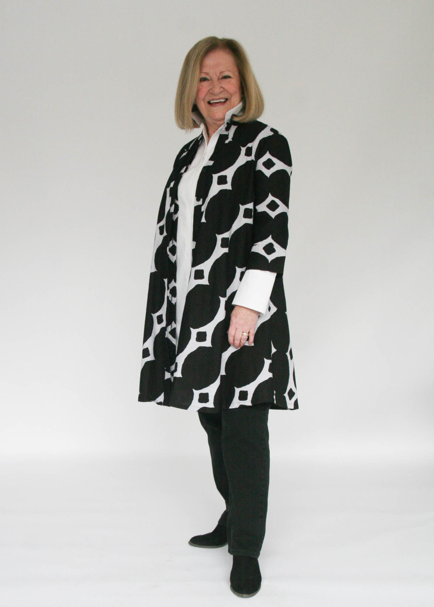 Model wearing black and white geometric print dress.