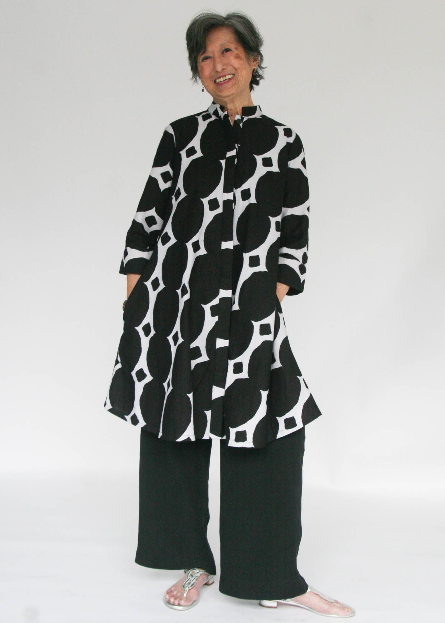 Model wearing black and white geometric print dress.