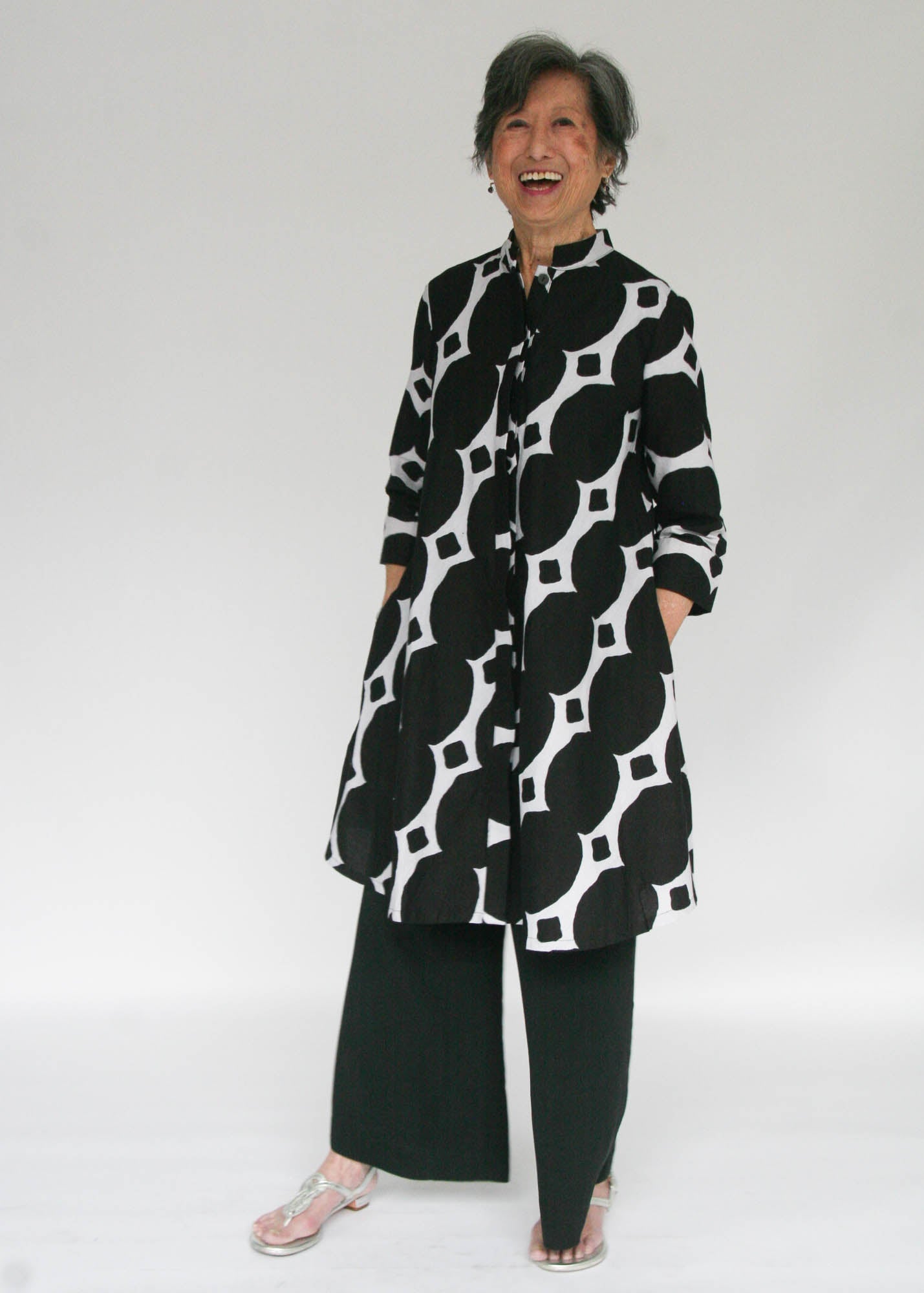 Model wearing black and white geometric print dress.