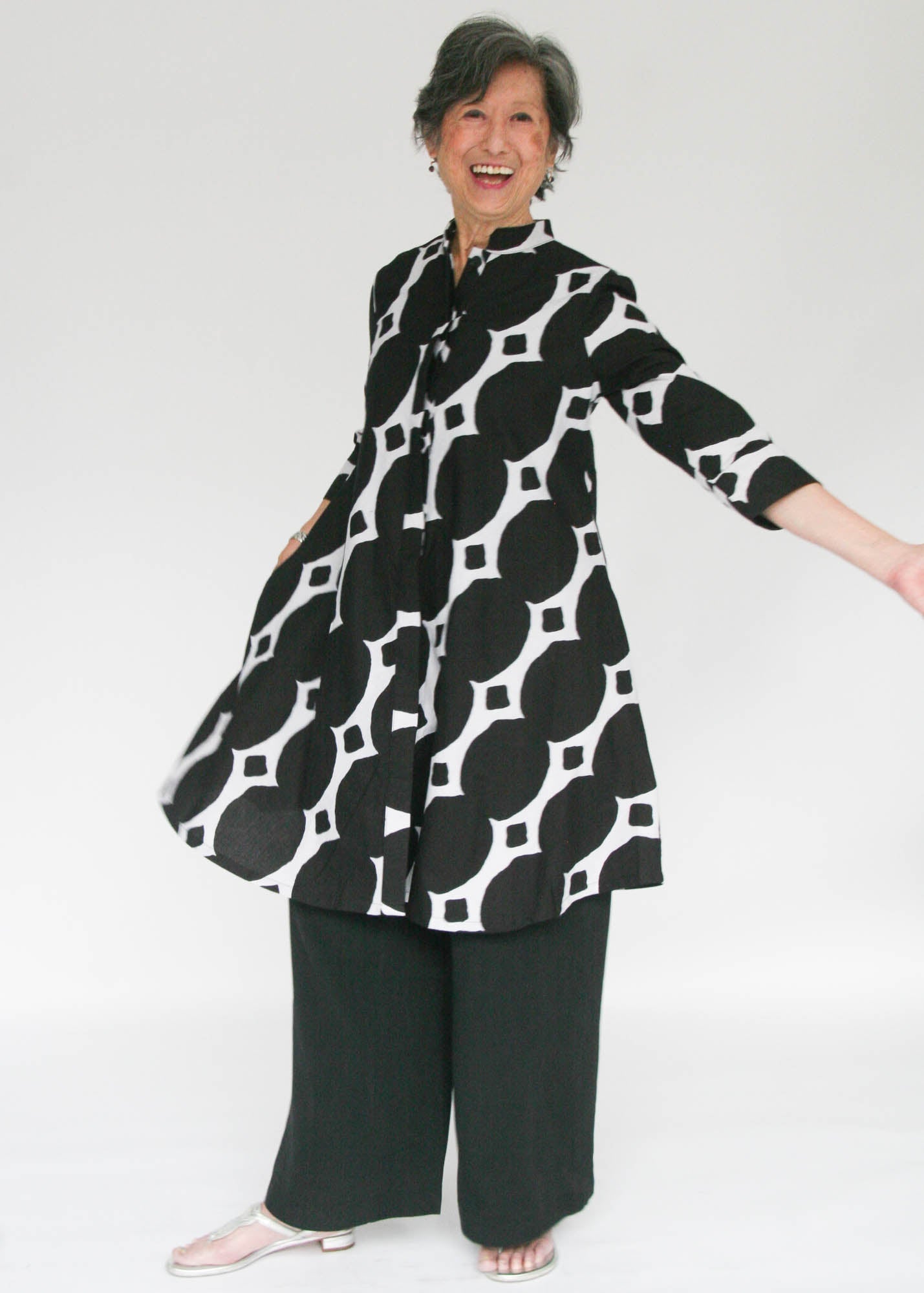Model wearing black and white geometric print dress.
