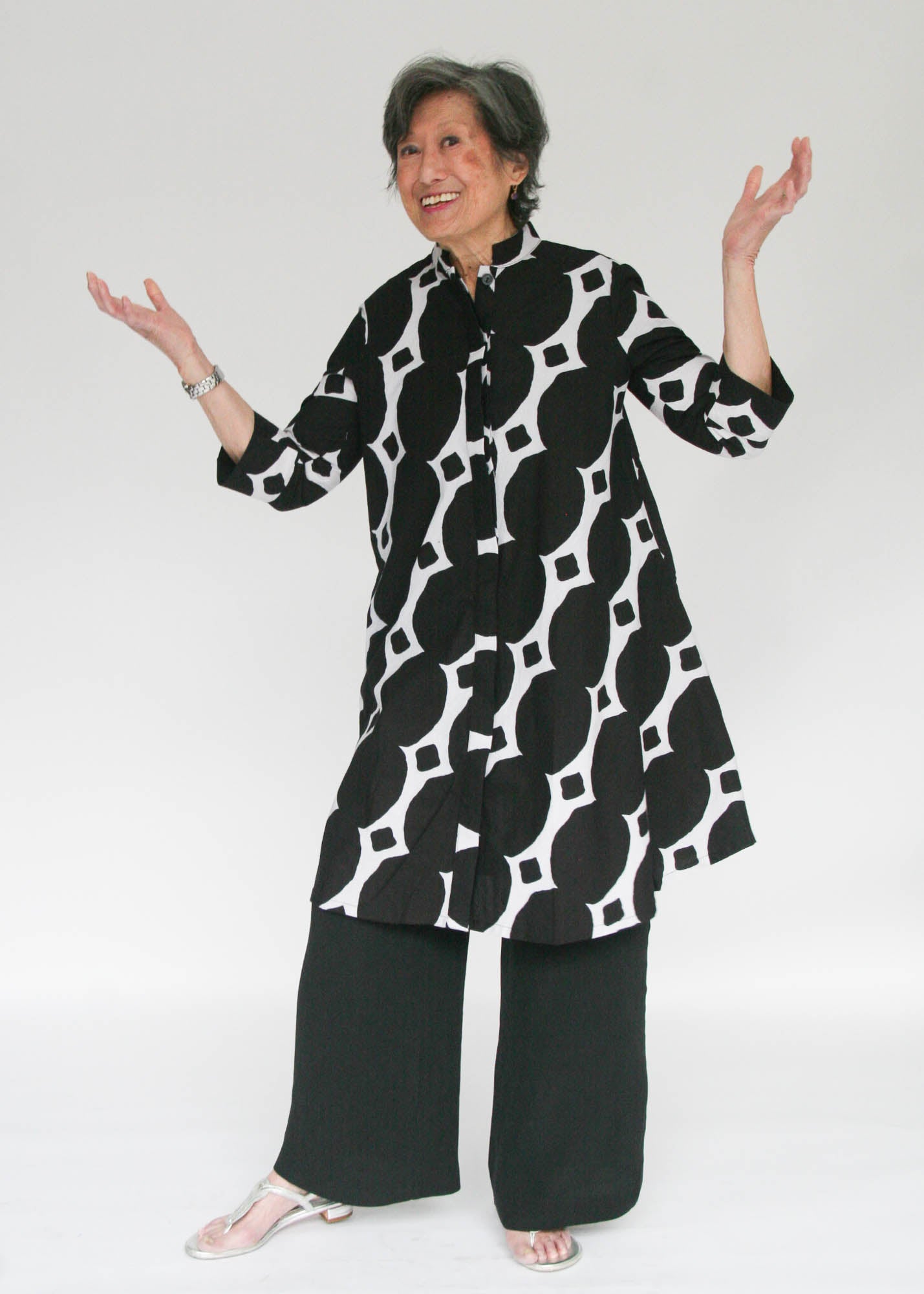 Model wearing black and white geometric print dress.