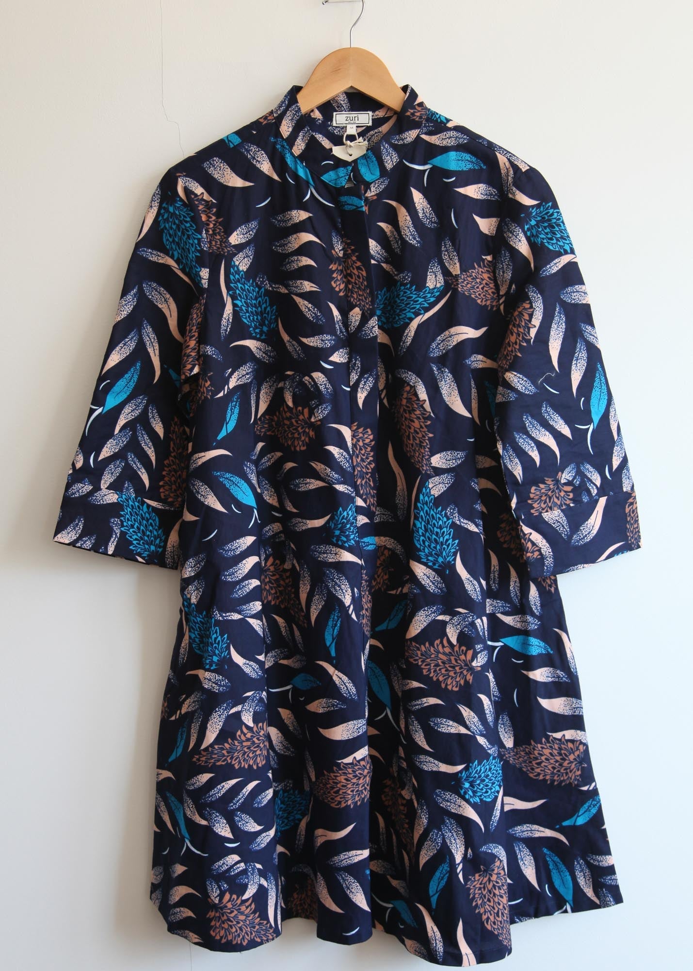 floral and leaf print navy dress on white background