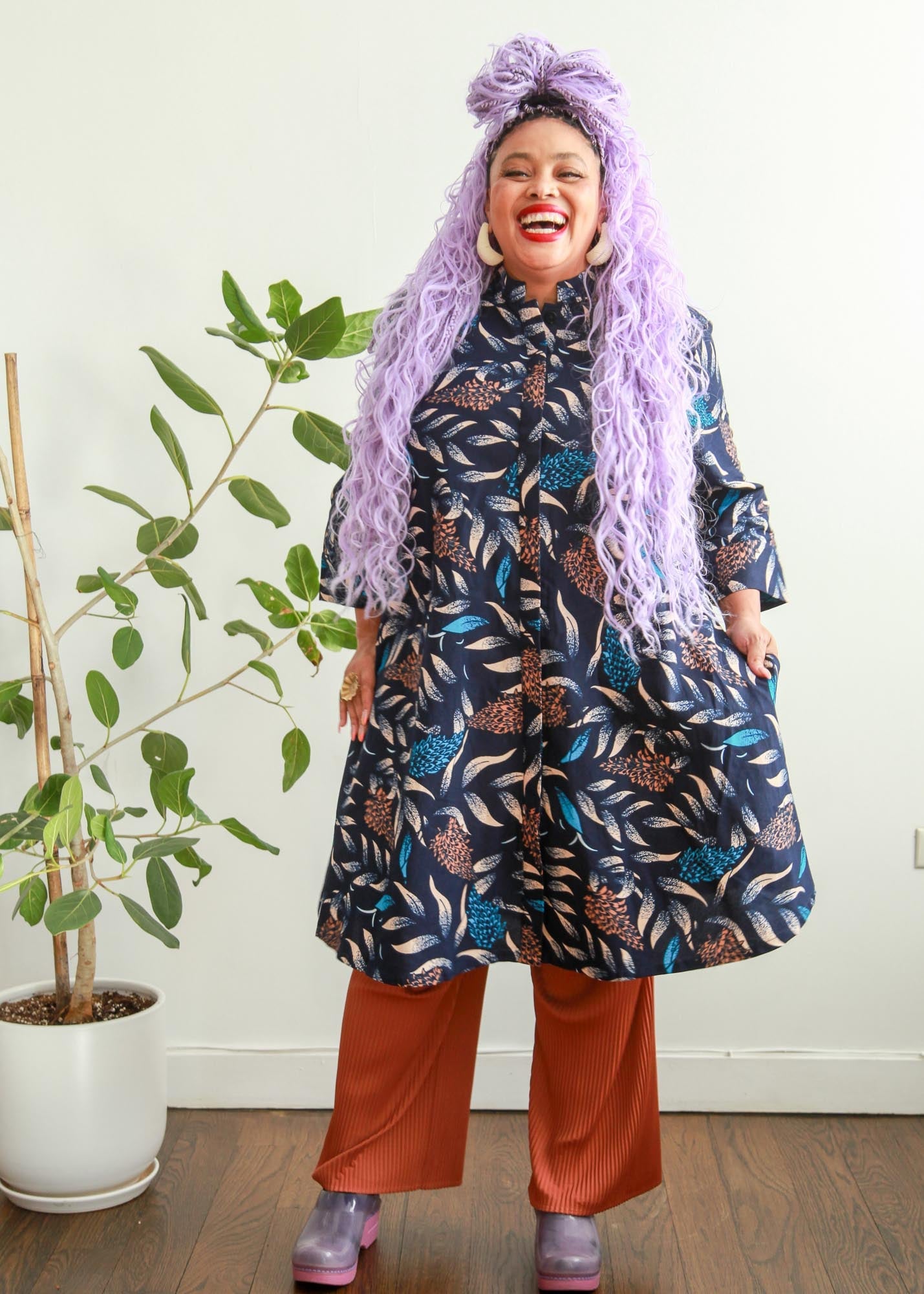 model wearing floral and leaf print navy dress 