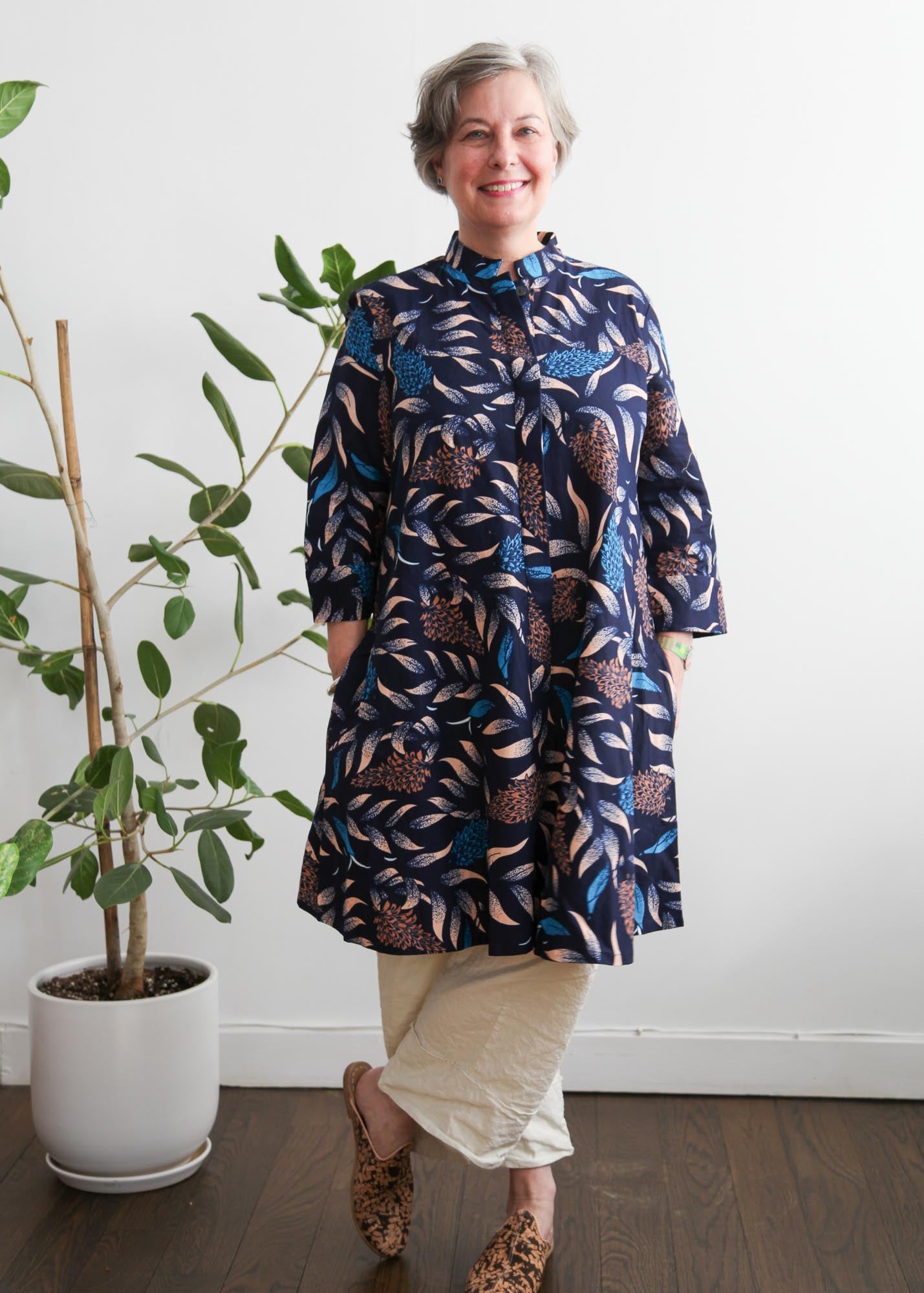 model wearing navy floral and leaf print dress