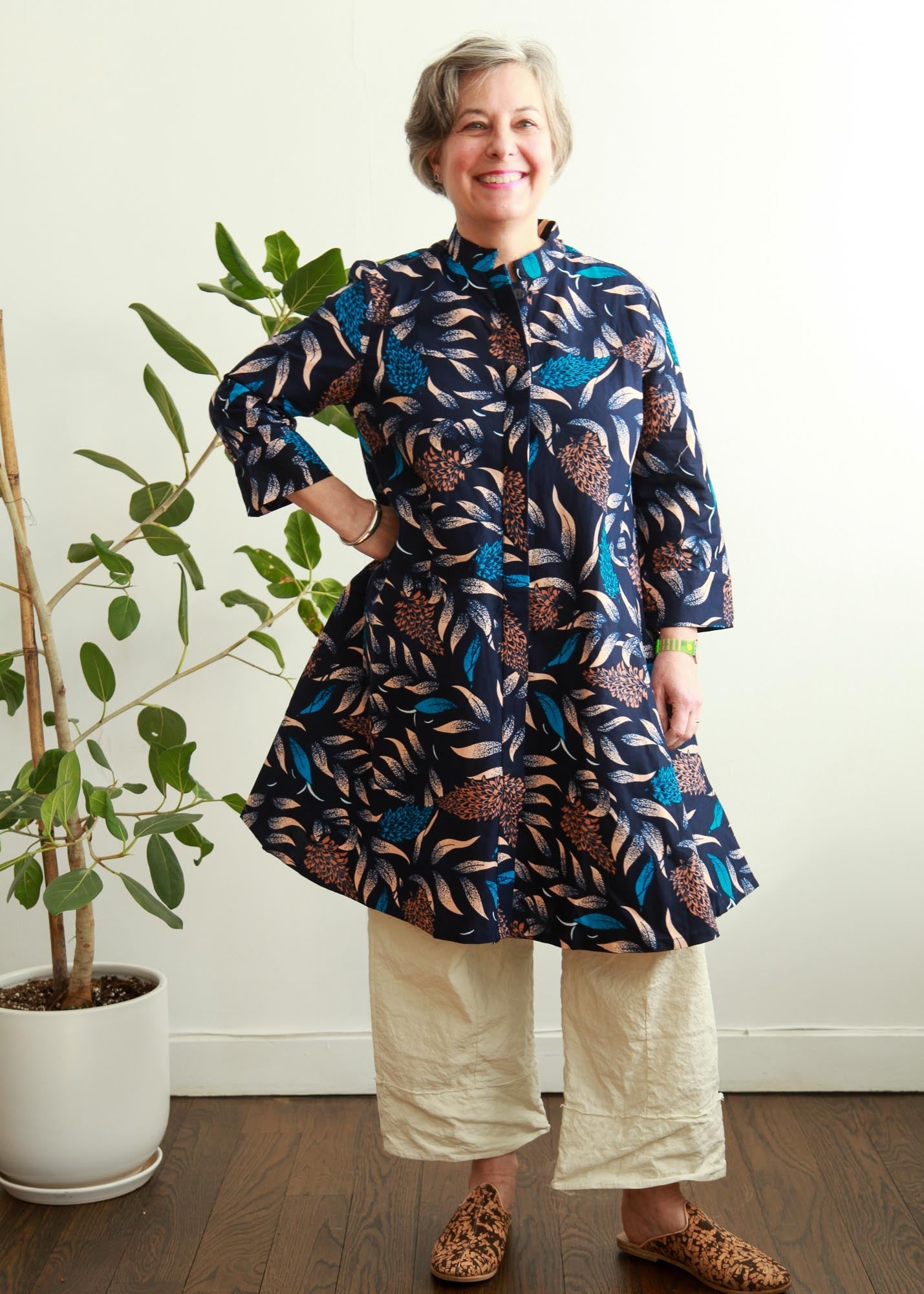 model wearing floral and leaf print navy dress