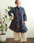 model wearing floral and leaf print navy dress