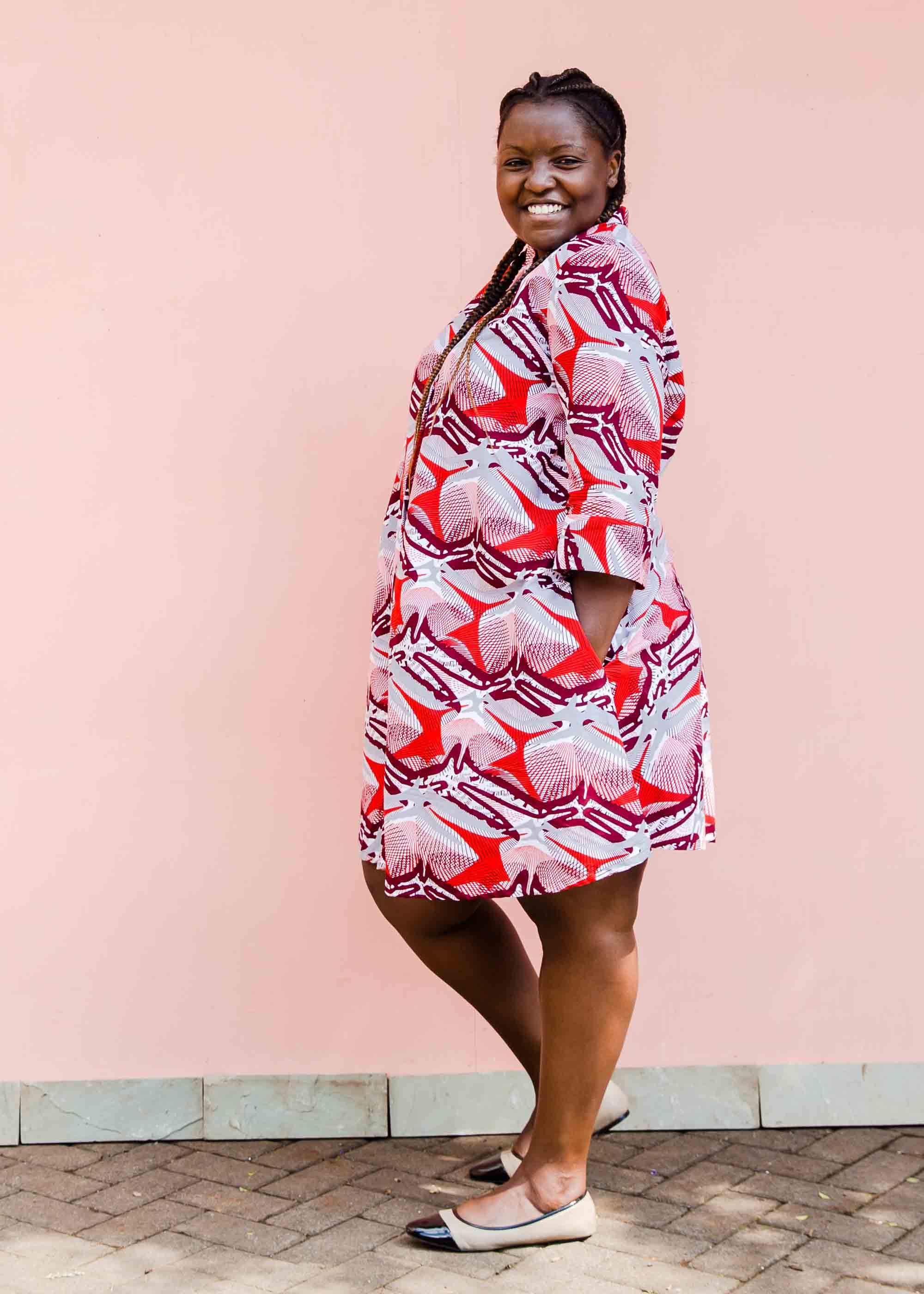 Model wearing a red, grey and maroon geometric shirt dress